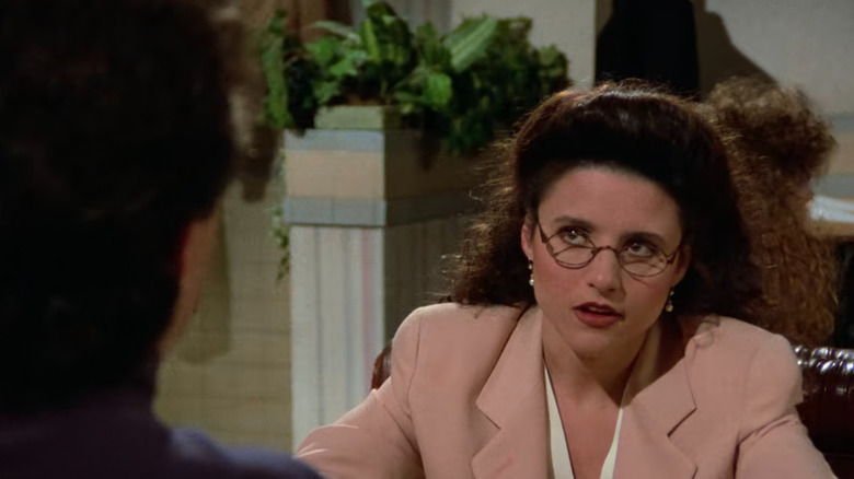 Elaine looking annoyed in restaurant in Seinfeld