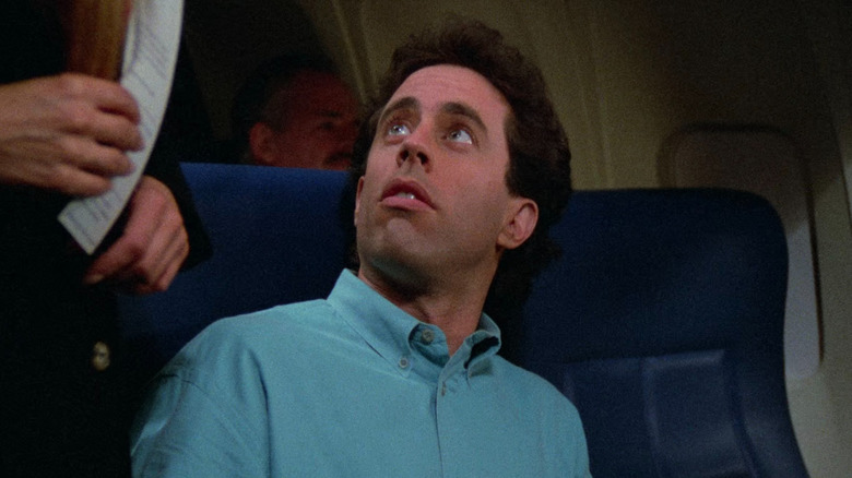 Jerry Seinfeld looking up from his airport seat in Seinfeld