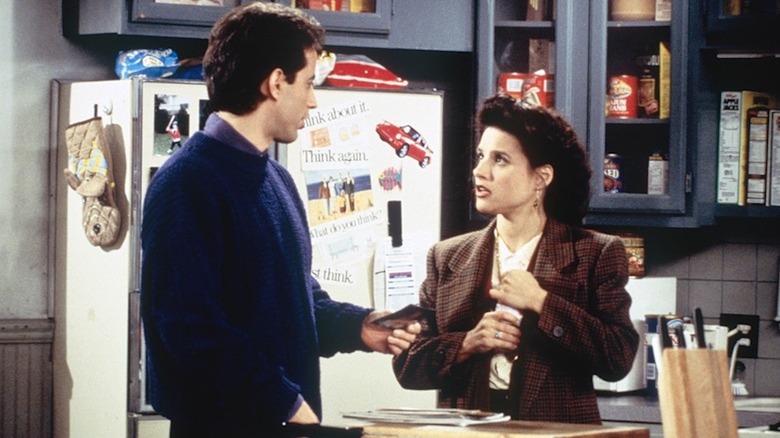 Jerry Seinfeld and Julia Louis-Dreyfus share a moment as Jerry and Elaine in an apartment kitchen in Seinfeld