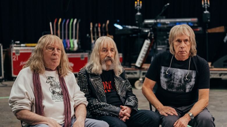 David St. Hubbins, Derek Smalls, and Nigel Tuffnel sitting for an interview in Spinal Tap II: The End Continues