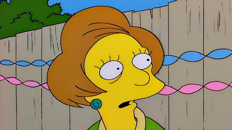 Edna Krabappel talking in front of a fence on The Simpsons