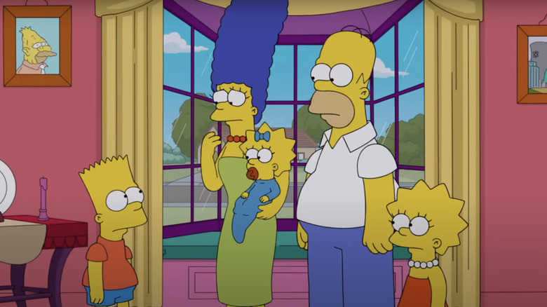 The Simpsons stand together in the living room by the window in The Simpsons
