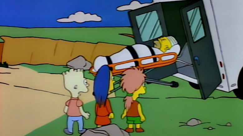 Homer Simpson, strapped to a stretcher, rolls out of the back of the ambulance in The Simpsons