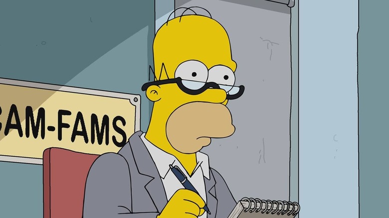 Homer with a pen and notepad sitting in a chair in The Simpsons