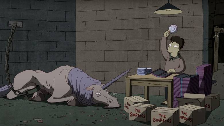 A malnourished unicorn is collapsed on the floor of a dungeon while a worker holds up a DVD in The Simpsons