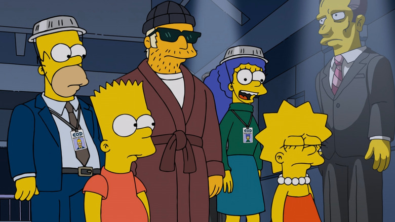 Duffman in a hat and bathrobe alongside the Simpson family in The Simpsons