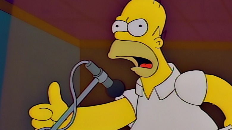 Homer yelling angrily into a microphone on The Simpsons