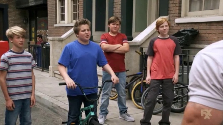 A group of kids taunt Mac and Charlie offscreen on It's Always Sunny in Philadelphia