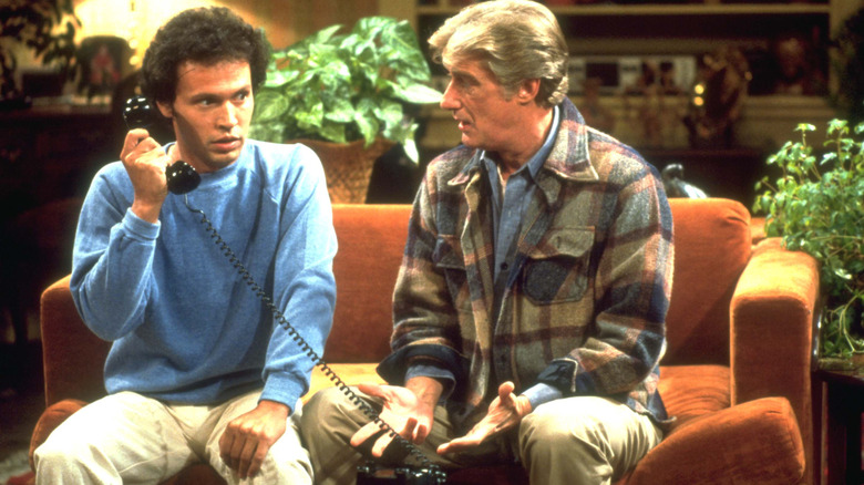 Jodie (on the phone) sitting next to Burt on a couch in Soap