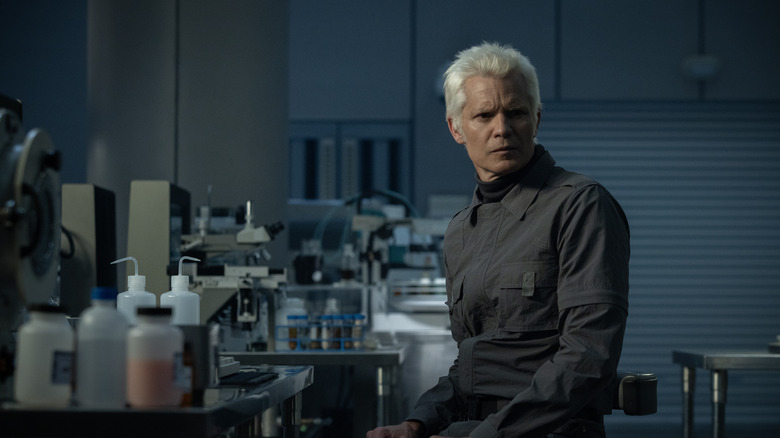 Kirsh looks over his shoulder with concern in a lab in Alien: Earth