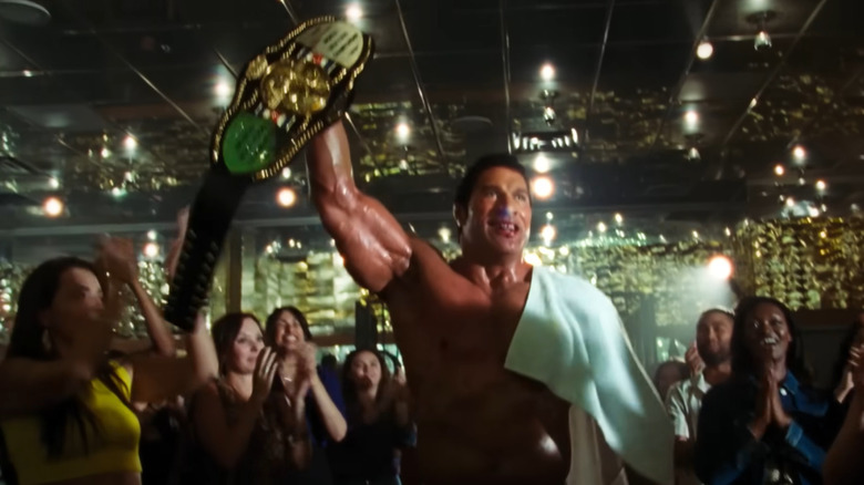 Dwayne Nsonson as Mark Kerr holding a championship belt in the breaking machine