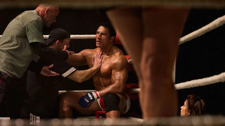 Dwayne Johnson as Mark Kerr sitting down in the octagon in The Smashing Machine