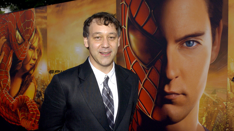 Sam Raimi in front of Spider-Man poster