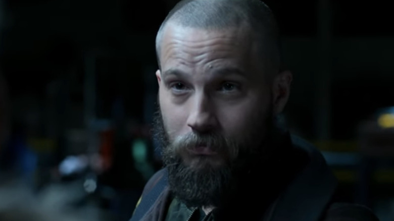 లోగాన్ మార్షల్-గ్రీన్ యొక్క జాక్సన్ బ్రైస్ స్పైడర్-మ్యాన్ హోమ్‌కమింగ్‌లో రాబందుల హెచ్‌క్యూలో నిలబడి ఉన్నప్పుడు క్లోజప్‌లో కనిపించాడు