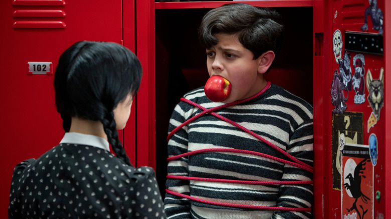 Wednesday looks at Pugsley tied up locker