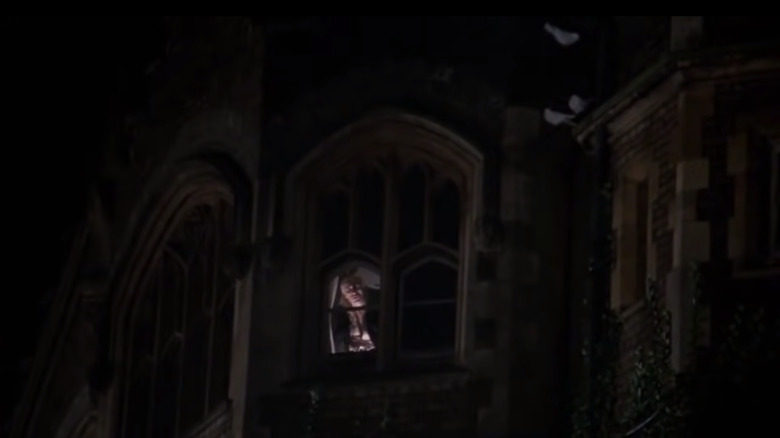 Riff Raff singing in the window of the castle.