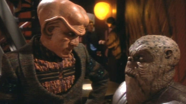 Mark Allen Shepherd as Morn and Armin Shimerman as Quark having an intense one-sided conversation on Star Trek: Deep Space Nine