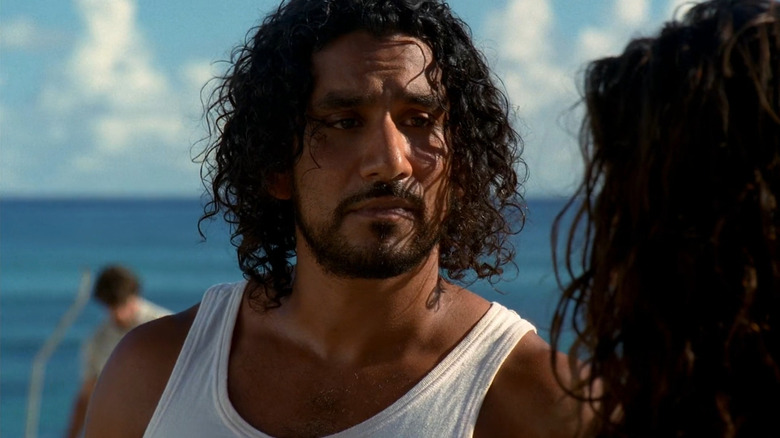 Naveen Andrews as Sayid Jarrah standing on a beach in Lost
