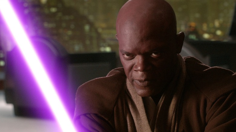 Samuel L. Jackson's Mace Windu igniting his purple lightsaber with a stern look on his face in Star Wars: Revenge of the Sith