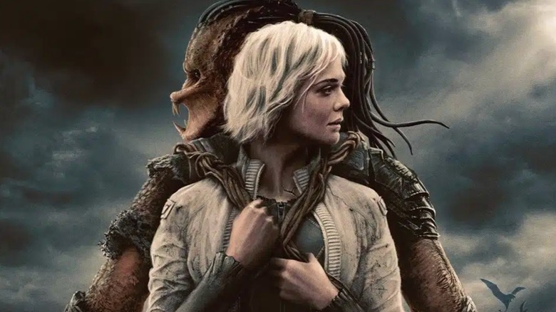 Predator: Badlands poster showing Thia strapped to Dek's back