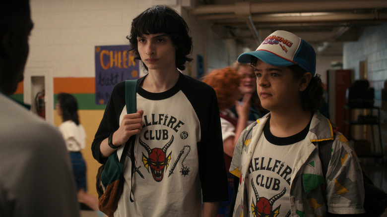 Mike and Dustin wearing their Hellfire Club shirts at school in Stranger Things
