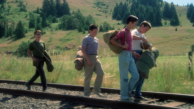Four boys walking along a railway track in Stand By Me