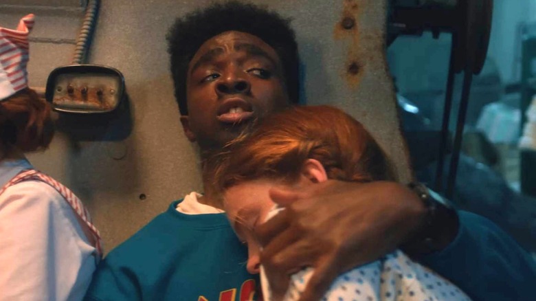 Max being held by Lucas in hospital while a demodog hunts them