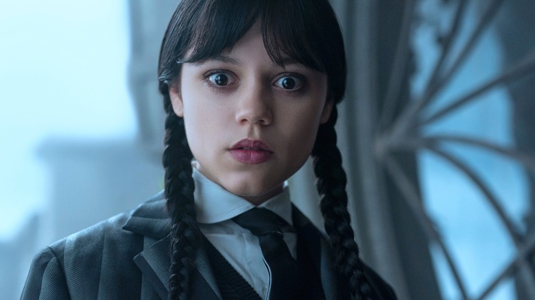 Wednesday stares at something surprising offscreen in Season 2 of Wednesday