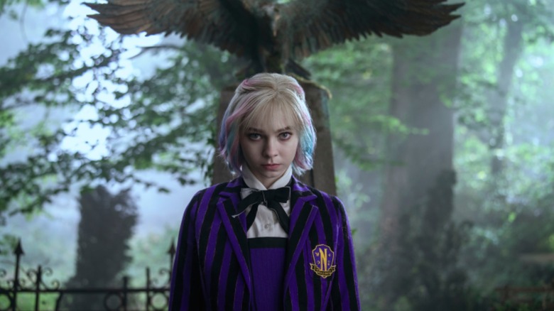 Wednesday (as Enid) stands near a grave in Jericho in Wednesday