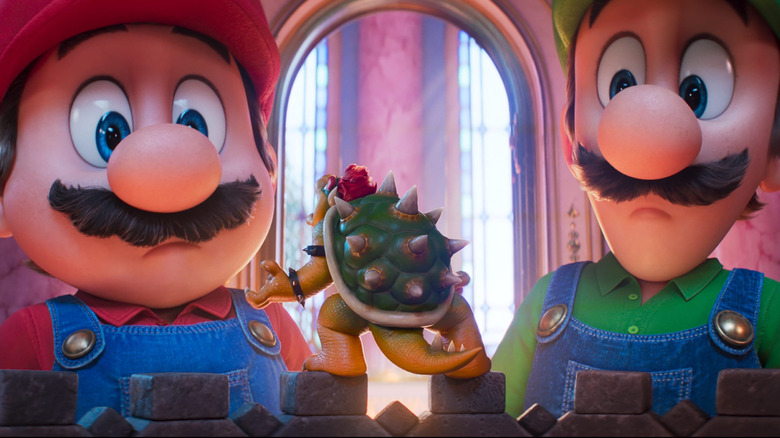 Mario and Luigi looking at tiny Bowser in The Super Mario Galaxy Movie