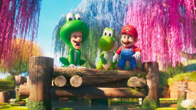 Luigi in a frog costume next to Yoshi and Mario in The Super Mario Galaxy Movie