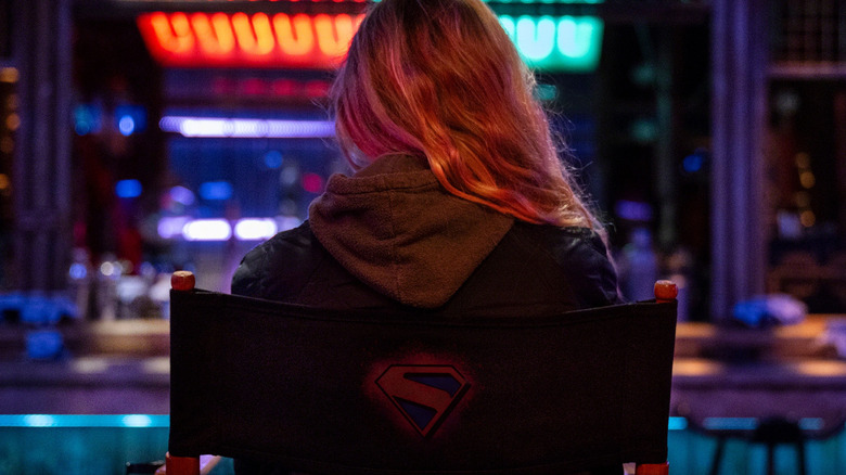 Milly Alcock sitting on the Supergirl set