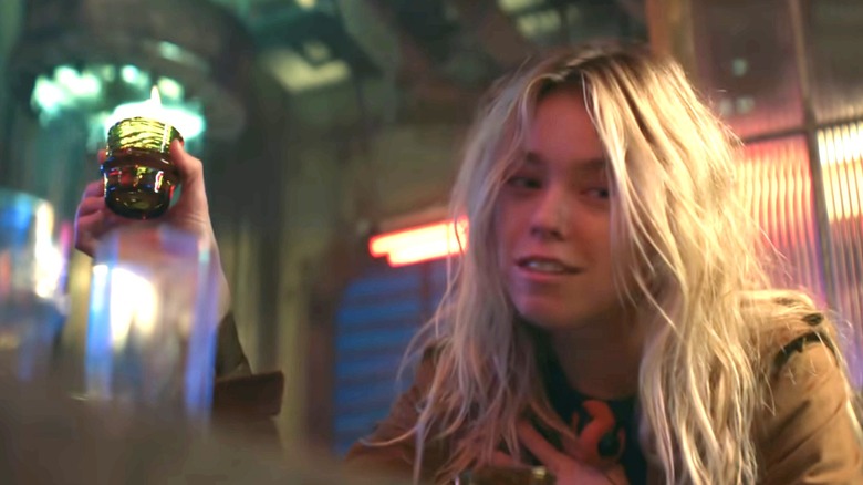 Milly Alcock's Supergirl about to drink a flaming shot