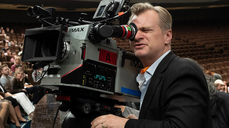 Christopher Nolan filming a scene for Tenet with an IMAX camera