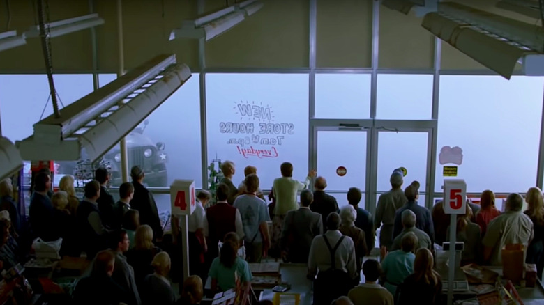 Shoppers in the supermarket observe the mist outside