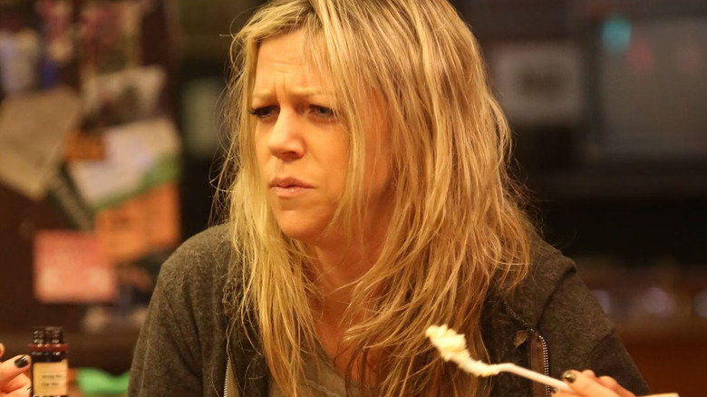 Dee (Kaitlin Olson) eats cake from a trash can in It's Always Sunny in Philadelphia