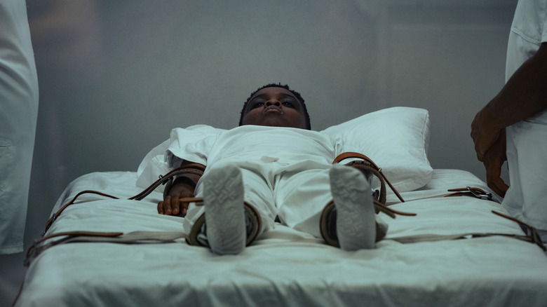 Anthony B. Jenkins' Andre tied up on the bed in The Deliverance