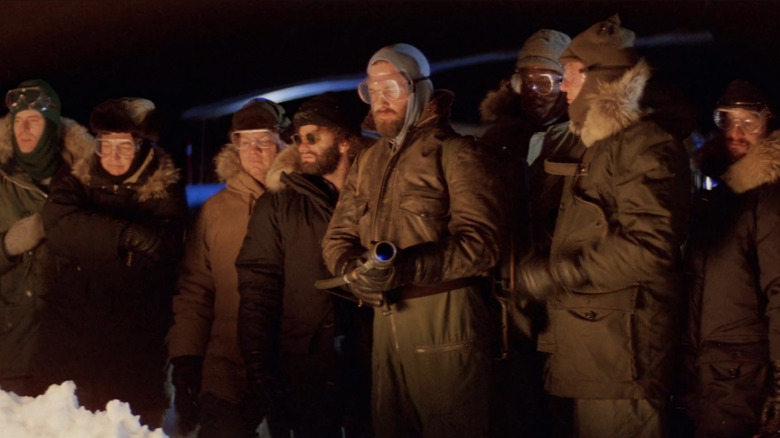 The cast of The Thing (1982) looking at a glowing light