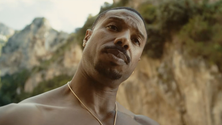 Michael B. Jordan as Thomas Crown cocking his head in The Thomas Crown Affair (2027)