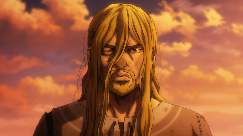 Vinland Saga season 2 -- Thorfinn, with bruised face, standing at sunsrt