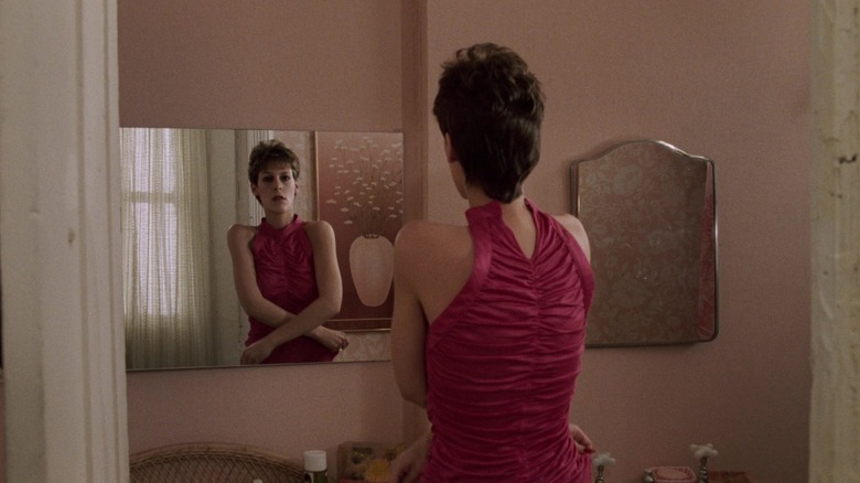 Jamie Lee Curtis looking in the mirror in Trading Places