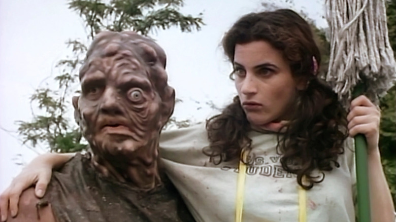 Sweetie Honey (Lisa Terezakis) puts her arm around the Toxic Avenger (David Mattey) in Citizen Toxie: The Toxic Avenger IV