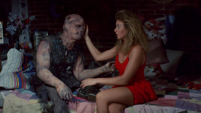 Sara (Andree Maranda) caresses the Toxic Avenger (Mitch Cohen) in The Toxic Avenger (1984)