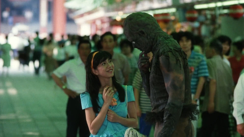 The Toxic Avenger (John Altamura) speaks with Masami (Mayako Katsuragi) in the streets of Tokyo in The Toxic Avenger Part II