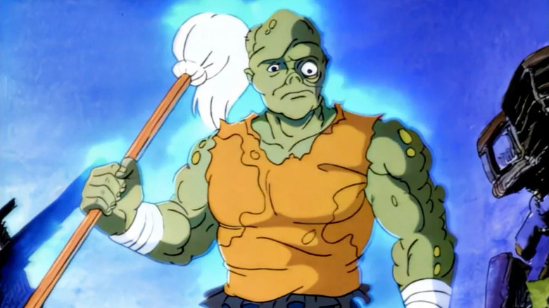 The Toxic Avenger (Rodger Bumpass) stands glowing with his mop in Toxic Crusaders