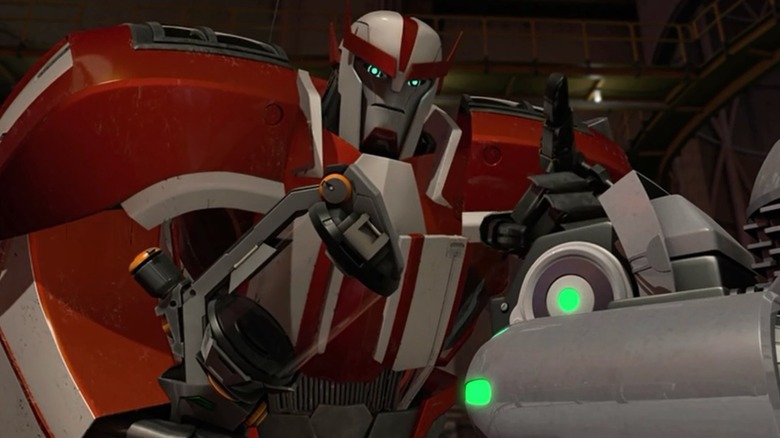 Ratchet holding an empty vial in Transformers: Prime