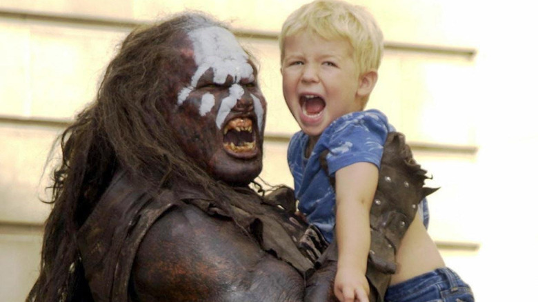 Uruk-hai warrior holding a child