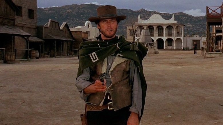 The Man with No Name holding a pistol in A Fistful of Dollars