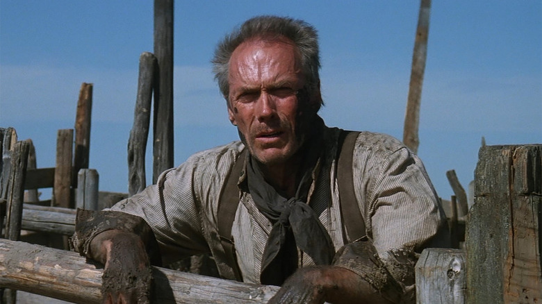 Clint Eastwood with muddy hands on a ranch in Unforgiven