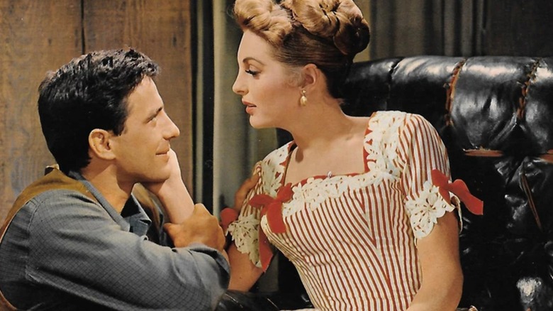 Joan and Tony share a tender moment in Saddle the Wind
